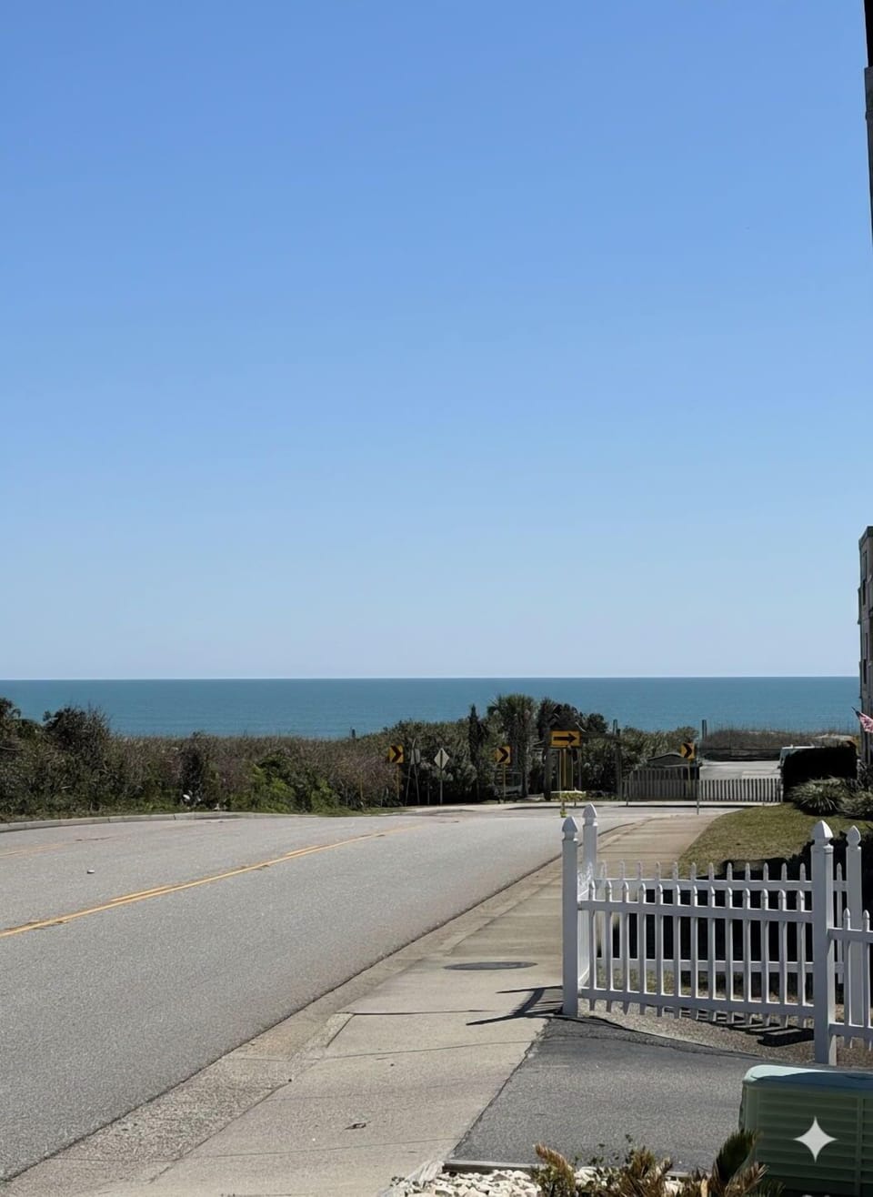 The ocean greets you as you approach the housing development.
