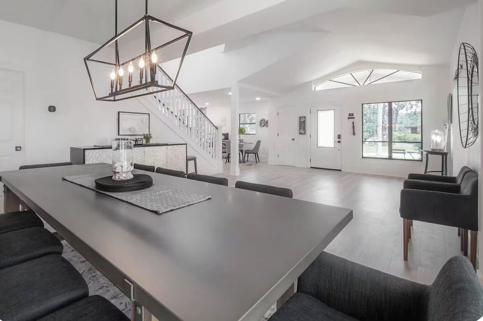 Bright open-plan living with vaulted ceilings, sleek dining, and garden views