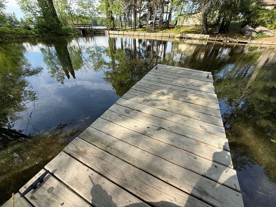 Private dock on a peaceful, tree-lined waterfront retreat