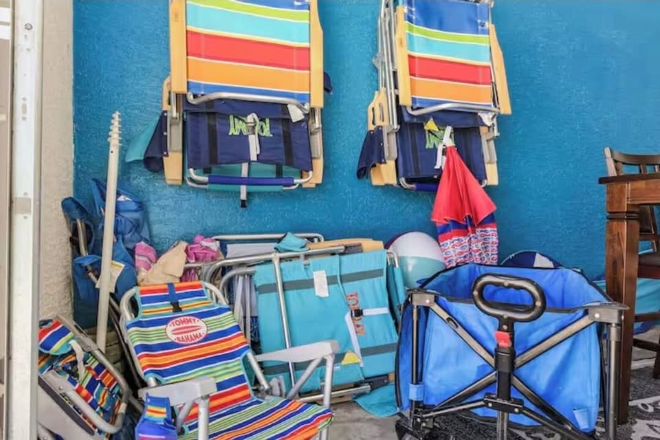 Everything you need for a beach day! Umbrella, cooler, wagon, and beach chairs.