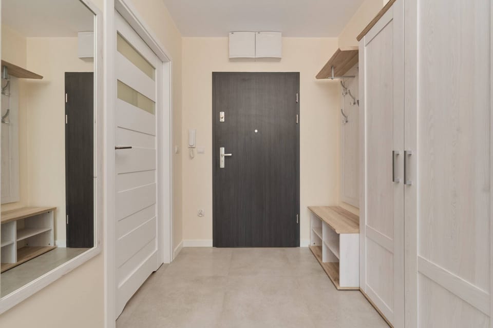 Spacious entry hallway with storage cabinets and a clean, inviting atmosphere.

