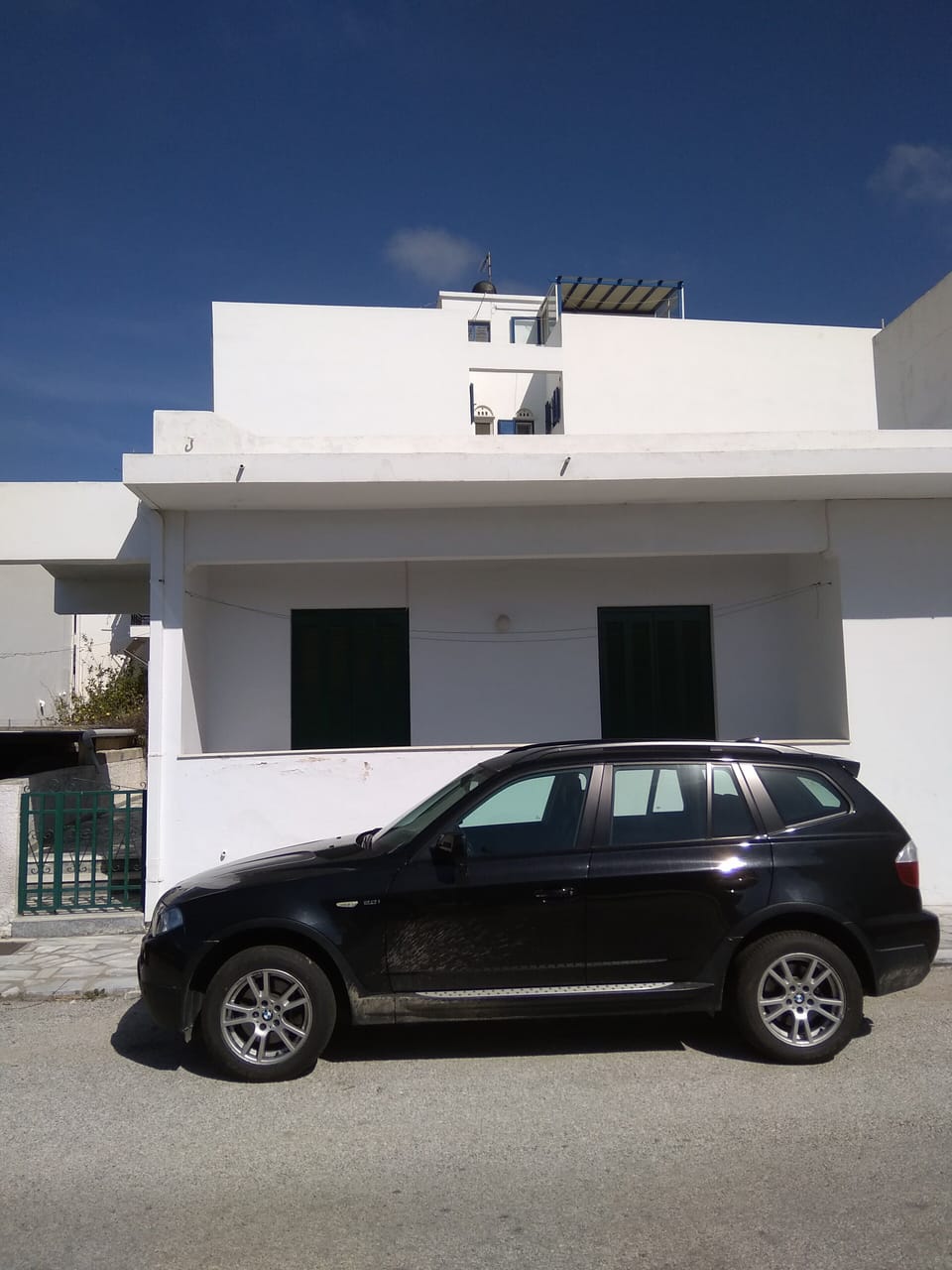 Double balcony and gate leading to front door. Ample parking spaces can be found