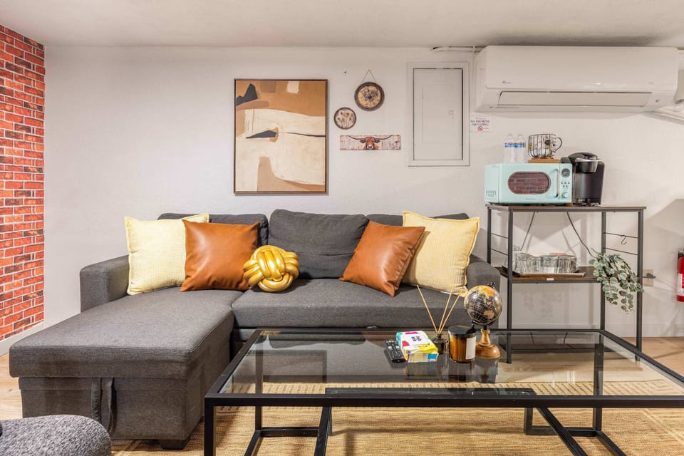 Stylish lounge with a brick accent wall and cozy seating for relaxing evenings.
