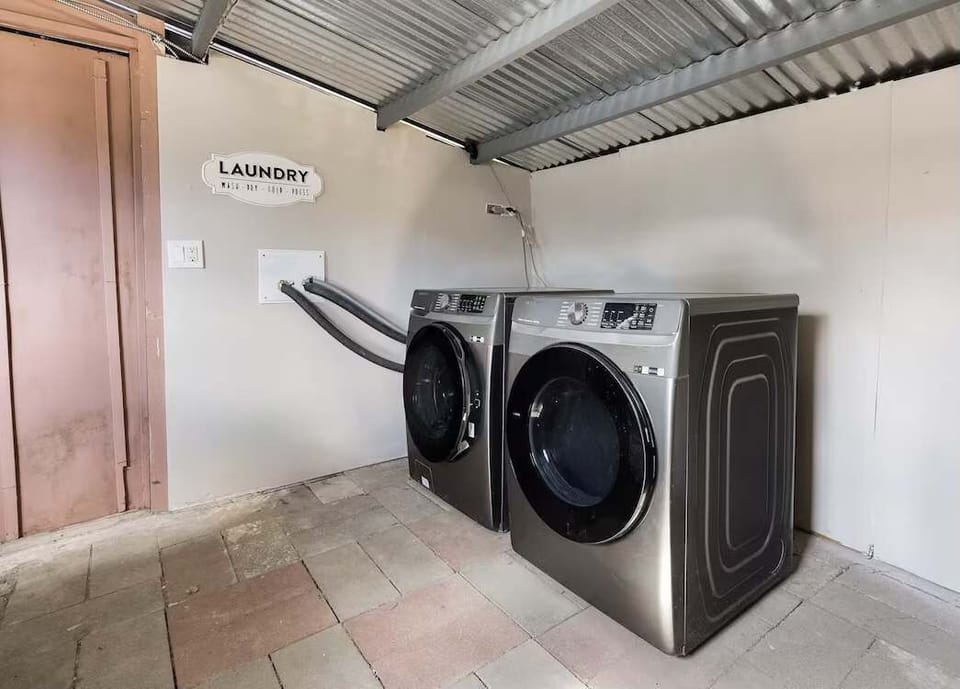 Covered laundry area offering convenience and practicality. This is the shared laundry with another unit.