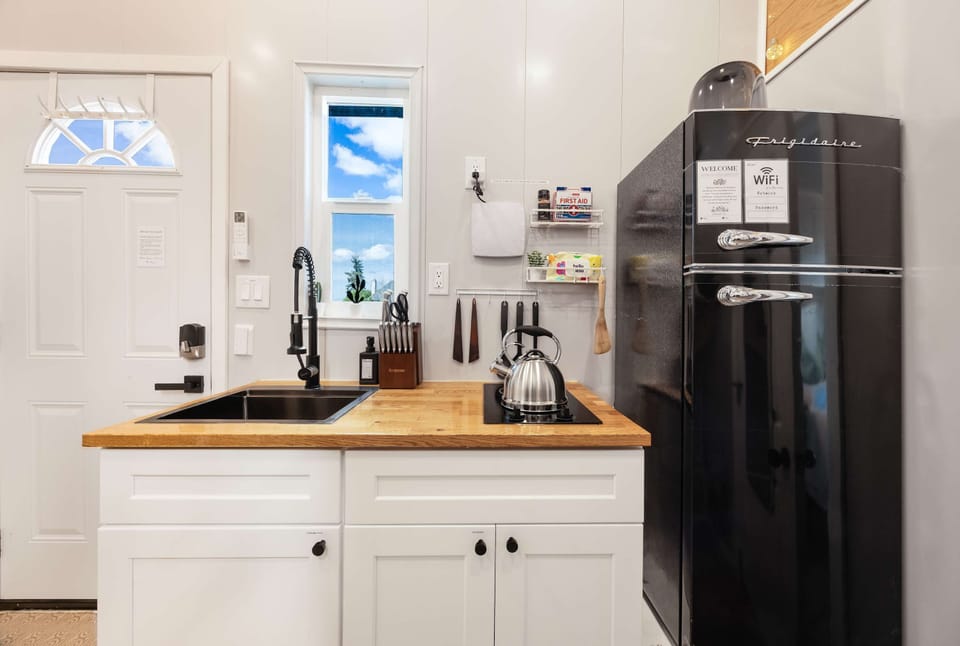 Bright, modern kitchenette with a retro-style fridge