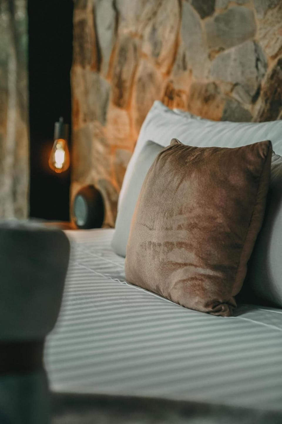 Nestle into crisp linens as soft amber lighting glows.