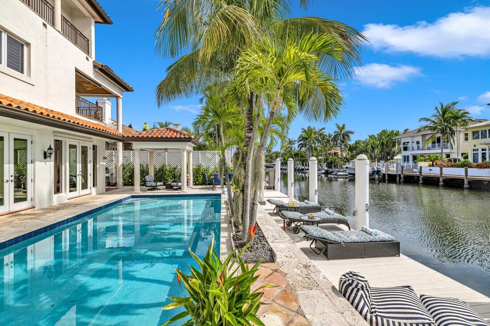 Private waterfront retreat with a sparkling pool, attached hot tub and shaded gazebo perfect for family relaxation