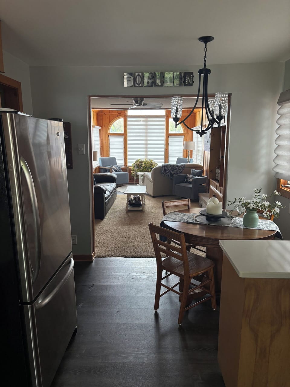 View into the living room and front seating area from the kitchen.