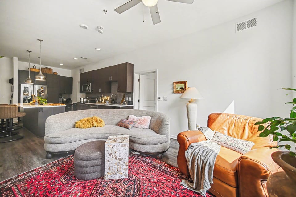 Stylish open living space with cozy seating and modern kitchen.