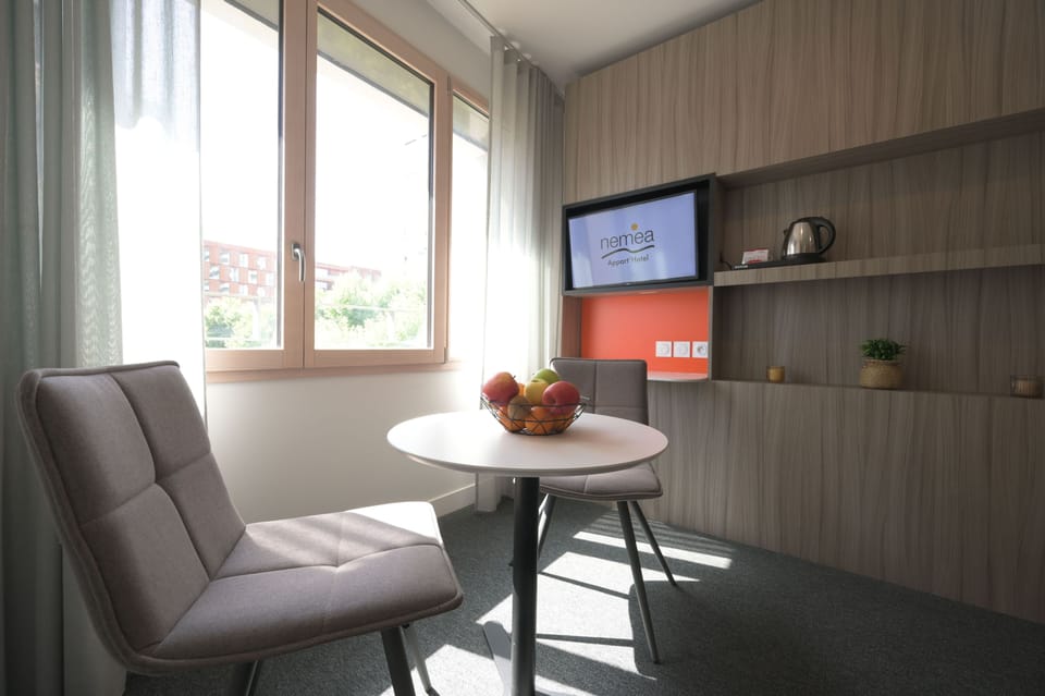 Dining and seating area by the window offering a pleasant space to relax.