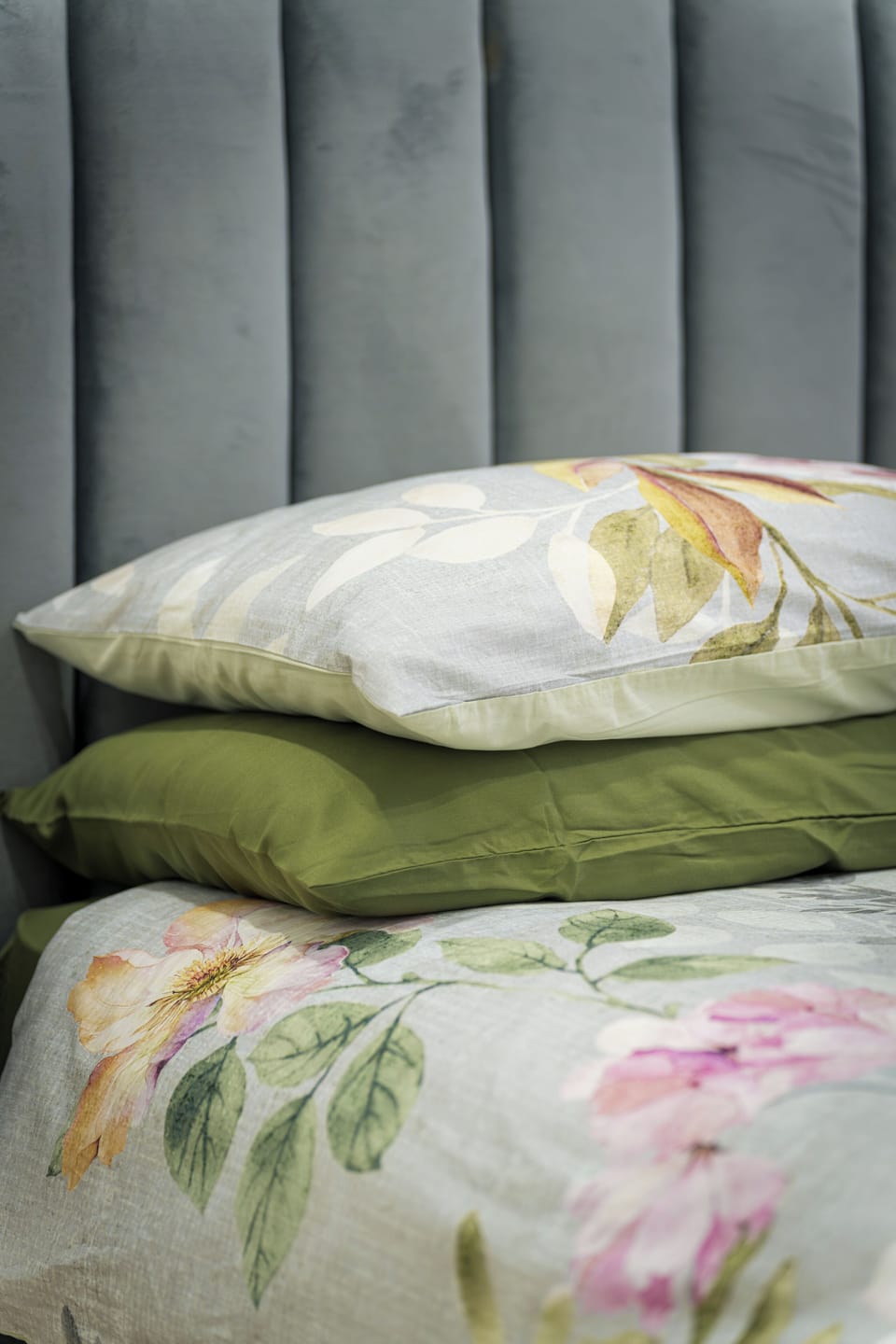 Cozy floral bedding with a plush upholstered headboard