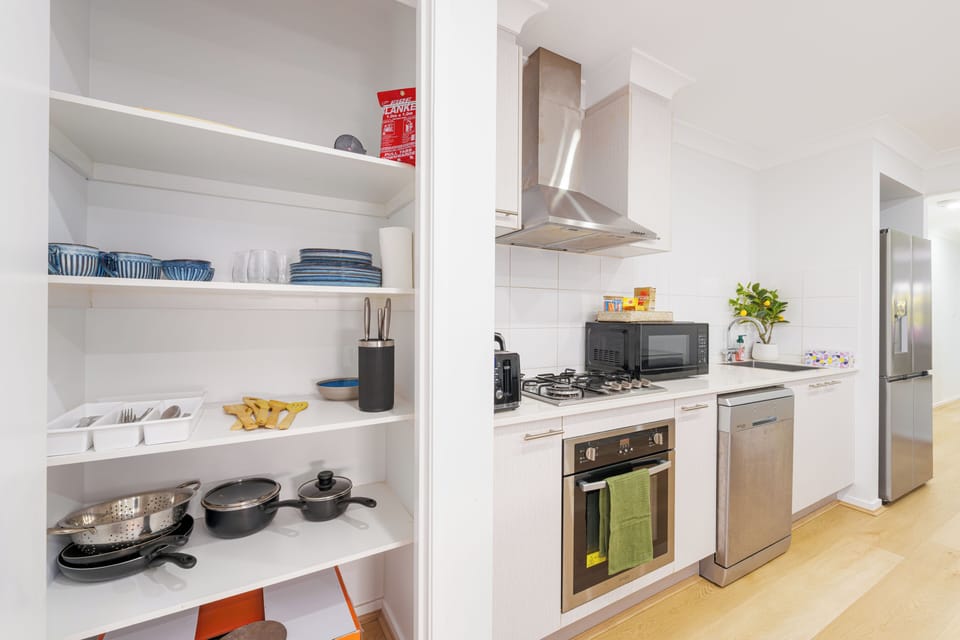 Bright modern kitchen with full appliances and a well-stocked pantry