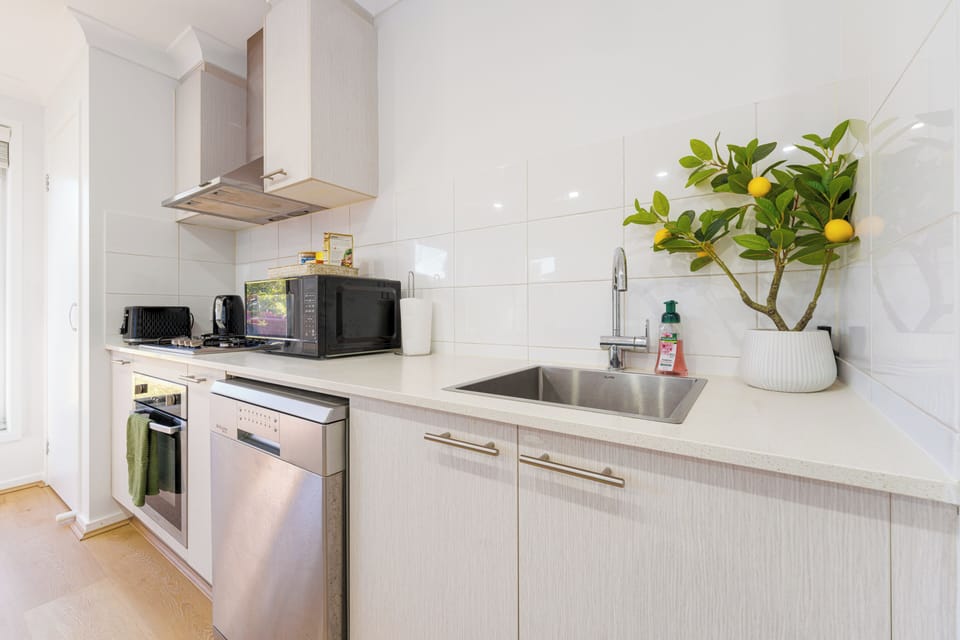 Bright modern kitchen with full appliances and fresh, stylish finishes