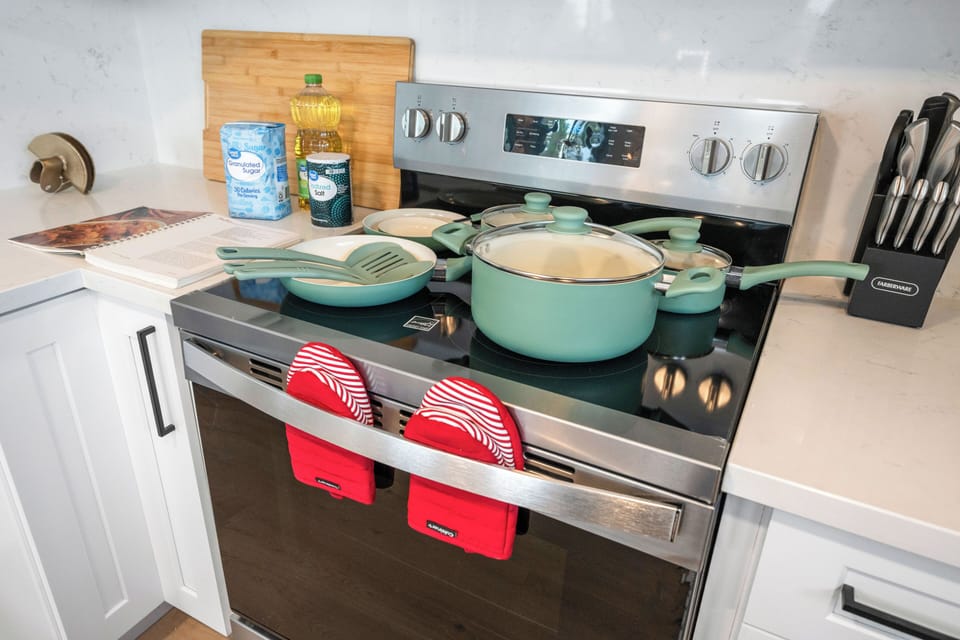 Fully equipped kitchen with pots and pans ready for cooking.