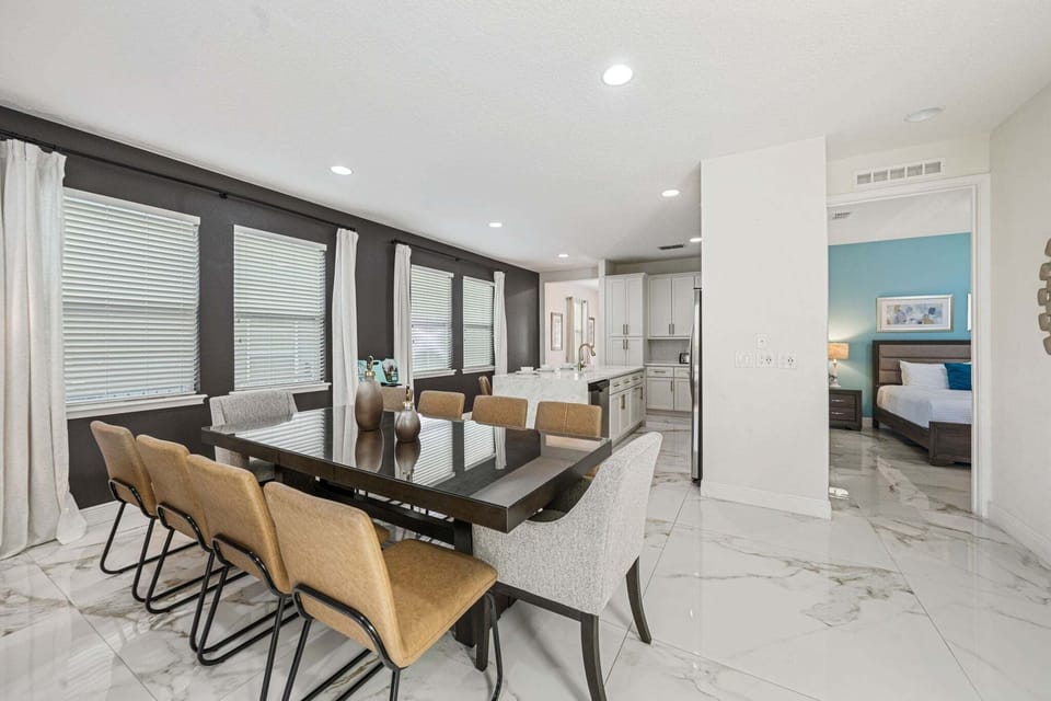 Host meals at a long dining table set beside an open kitchen, perfect for group gatherings