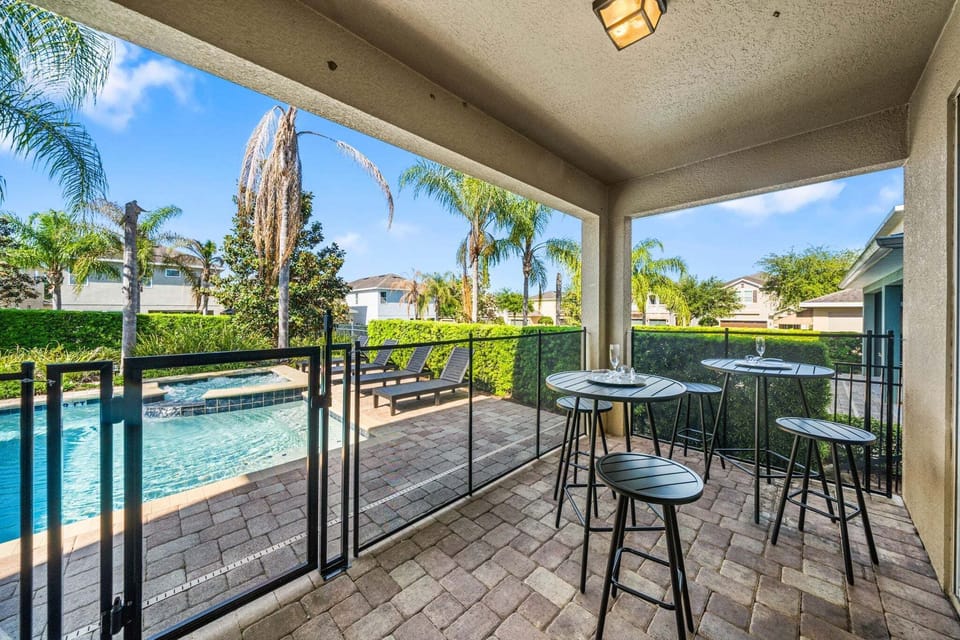 Lounge under the covered patio w/ shaded seating & views of the sparkling pool