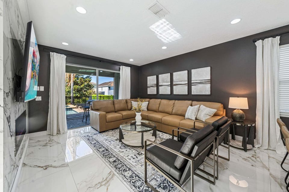 Relax in a bright living area w/ comfy seating, large windows & easy flow for gathering together