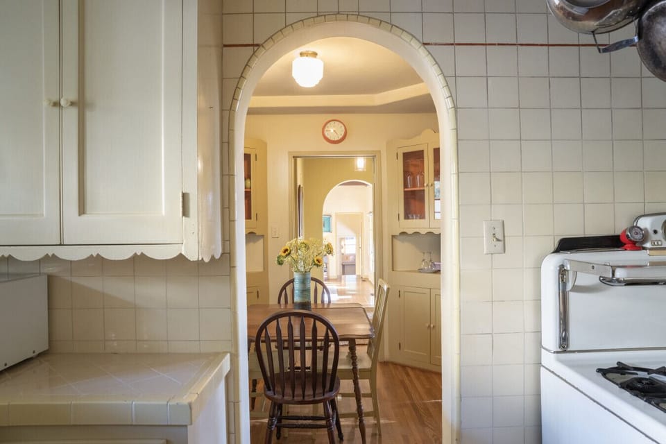 Arched doorway connecting the kitchen to the dining area — a thoughtful layout that makes the home feel cohesive and easy to live in.