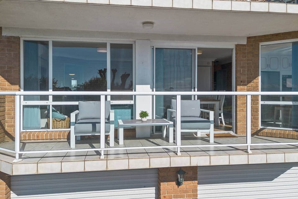 Enjoy a drink on the balcony with a golf course and sea view.