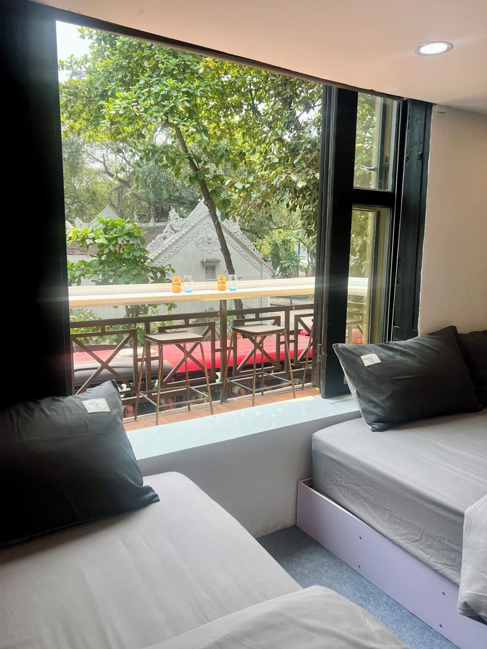 Window-side seating with greenery and a glimpse of the lake