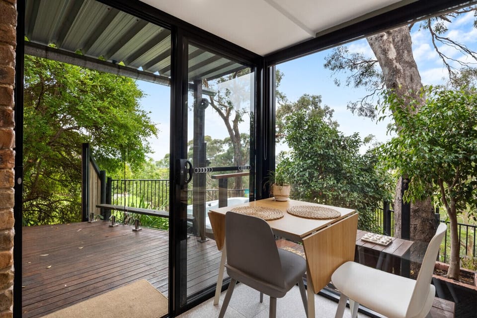 Enjoy meals by the window with leafy outlooks, natural light, and a cosy dining setting.