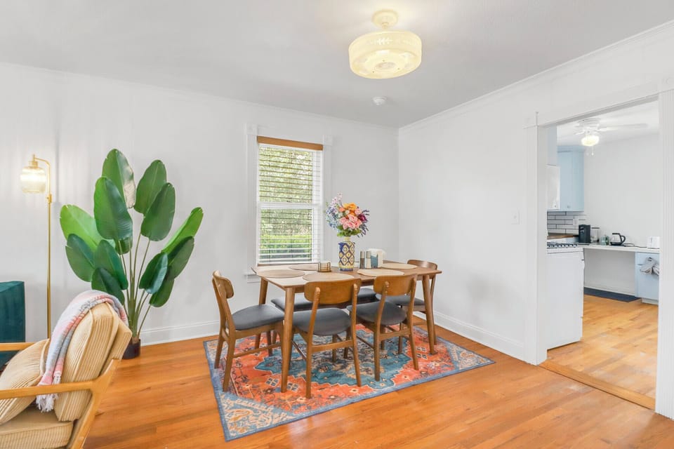 Gather around this beautiful wooden dining table where conversations flow as easily as morning coffee from your adjacent kitchen.