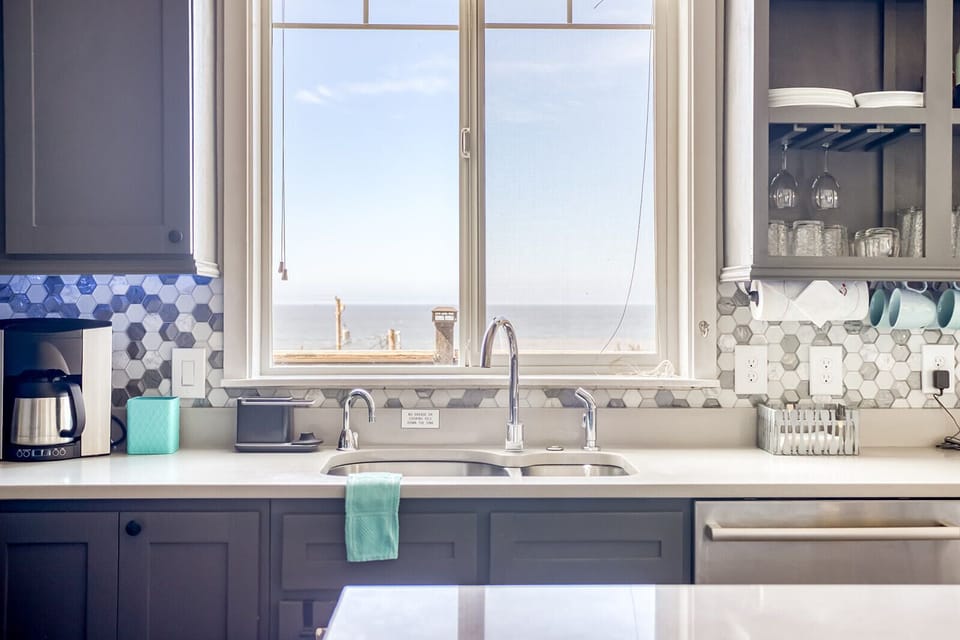 You'll love preparing meals in this bright, modern kitchen with stunning sea views through large windows.