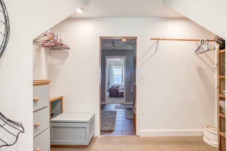 Your personal walk-in closet awaits with built-in storage benches, hanging rods, and thoughtful organization space for all your belongings.