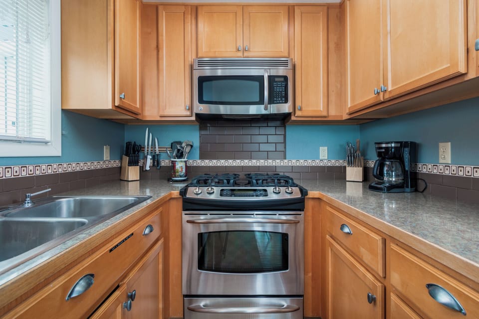 Cook your favorite meals in this fully equipped kitchen with stainless steel appliances, spacious counters, and everything you need.