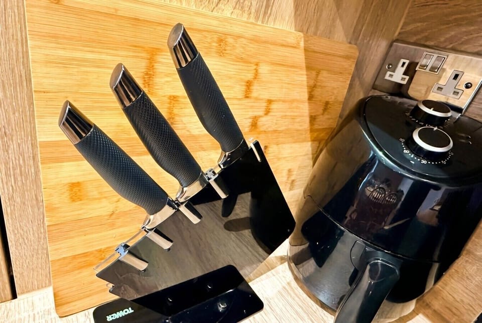 Kitchen knife block and air fryer ready for home cooking.