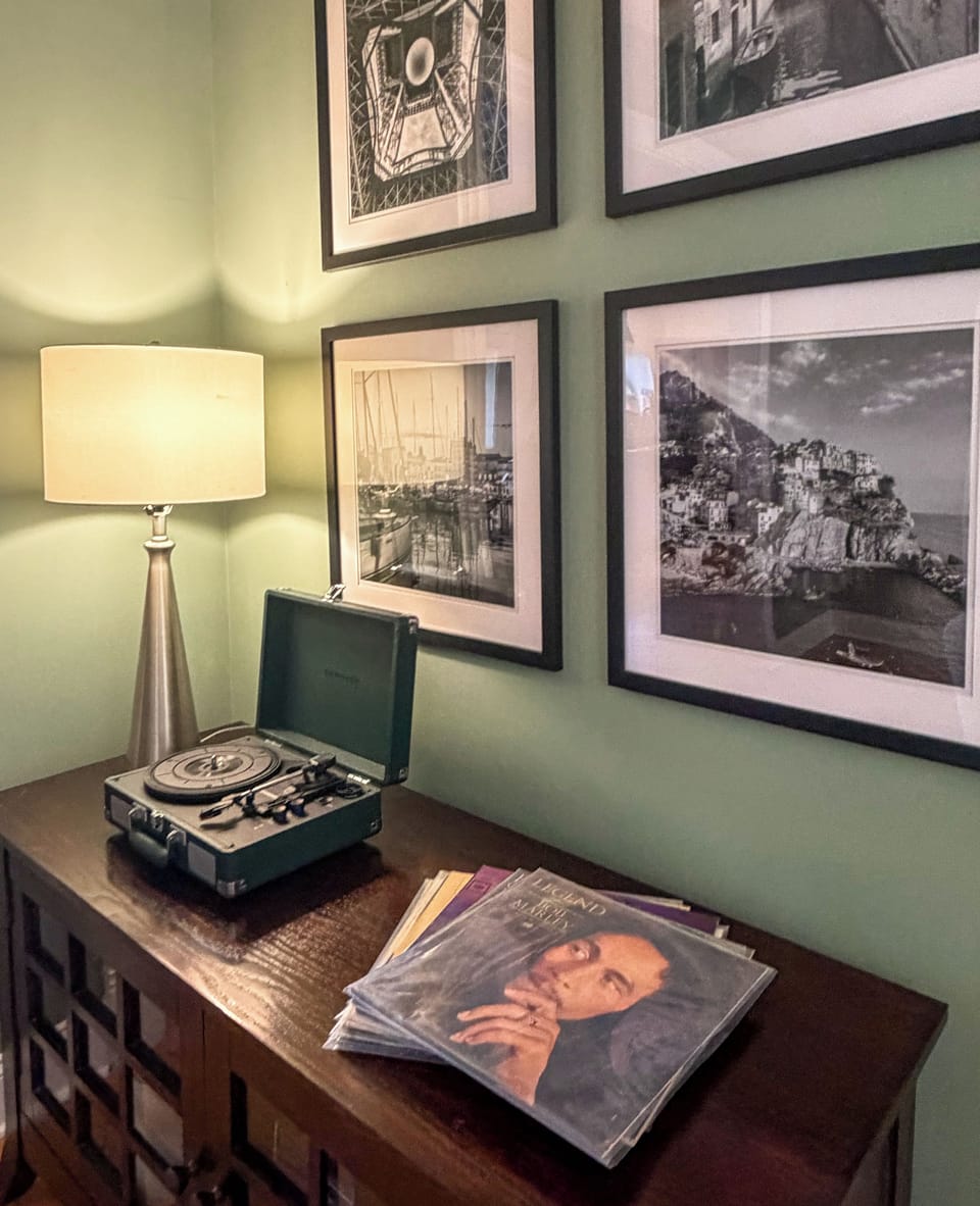 Vintage record player nook with warm lighting and stylish gallery wall