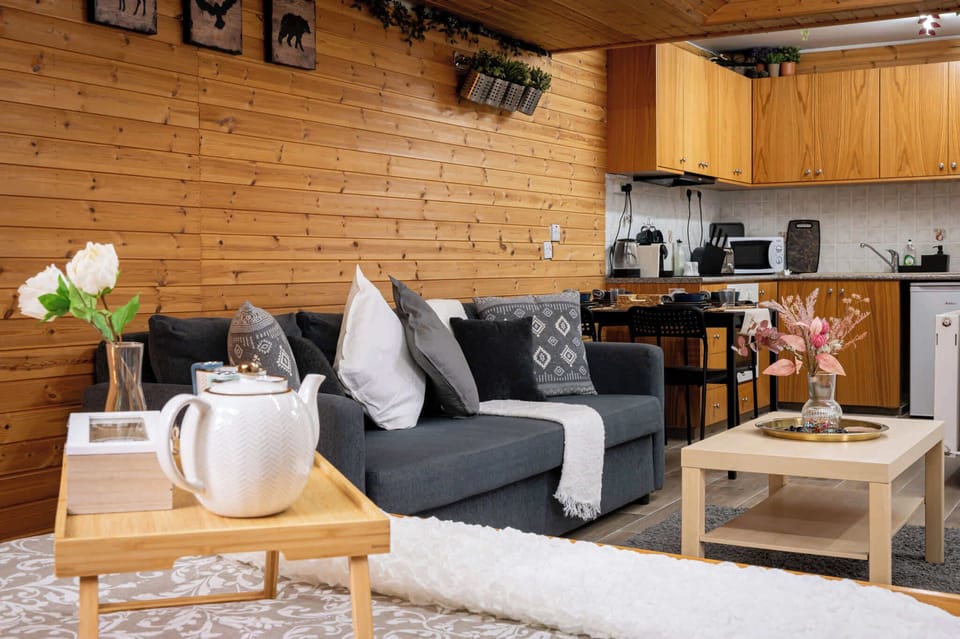 Unwind in the lounge area after a day of exploring and soak in the serene forest views from the comfort of your studio, letting the peaceful surroundings wash over you.