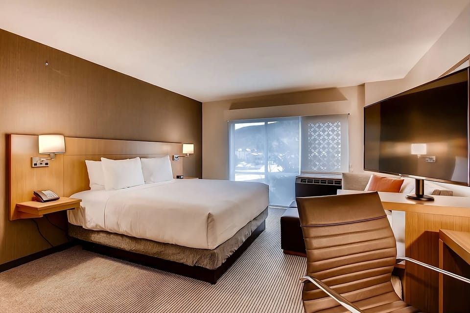 Settle in with a comfy bed, big TV, and desk.