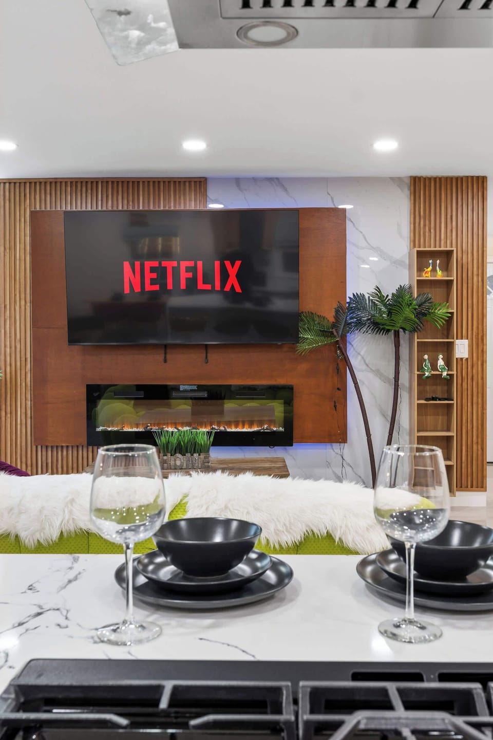 Modern living area with Netflix, cozy fireplace, and stylish dining setup.