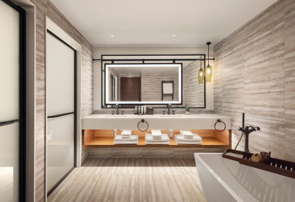 Unwind in a deep soaking tub under warm lighting.