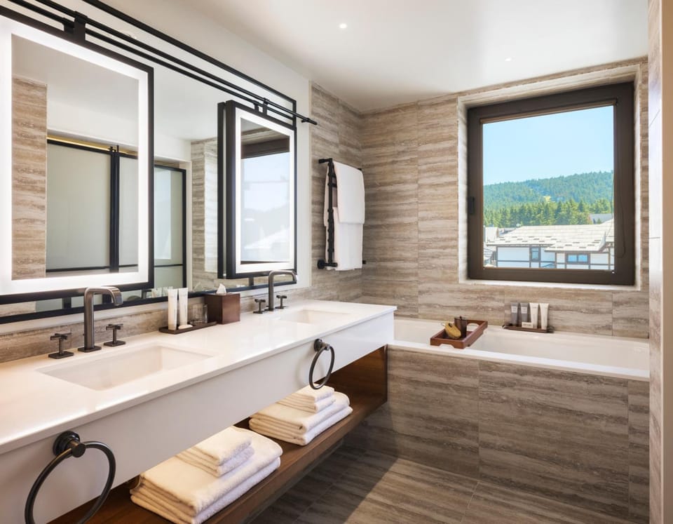 Linger at the double vanity with mountain views beyond.