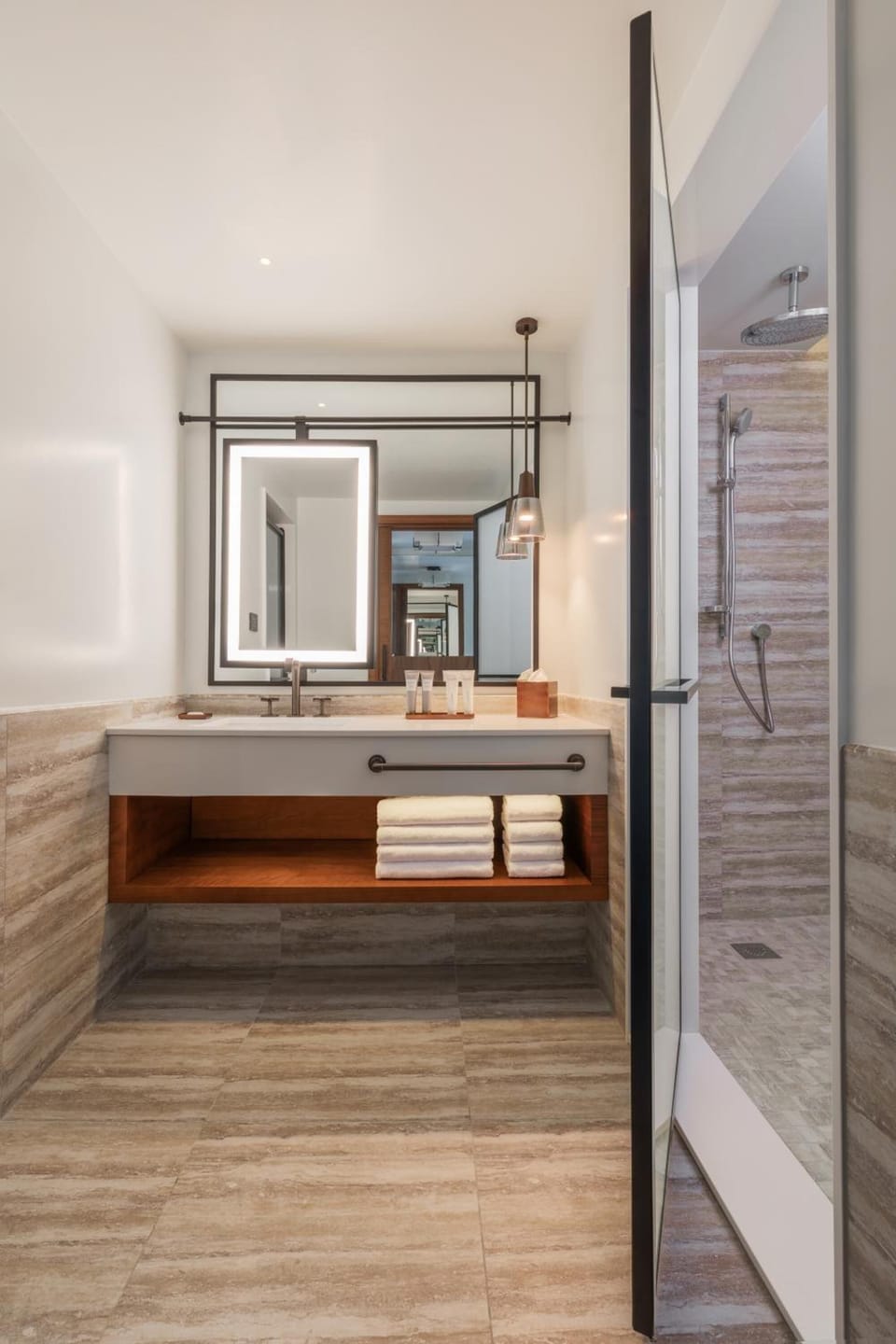 Refresh under a sleek rain shower with a spacious vanity.