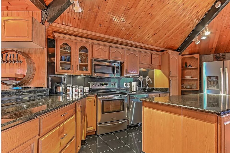 Kitchen features a spacious fridge with built-in ice maker.