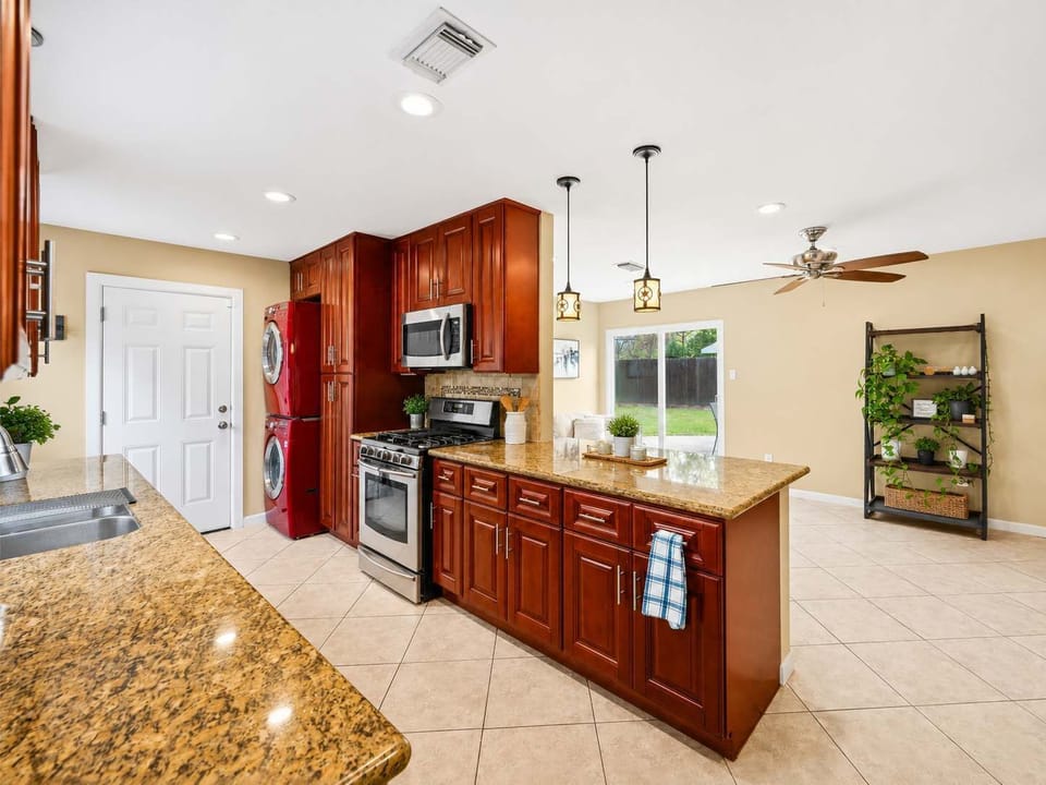 Kitchen: Bright, modern space with granite counters and vibrant cabinets, perfect for culinary adventures!
