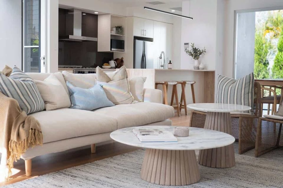 Beautifully styled living room with open plan kitchen.