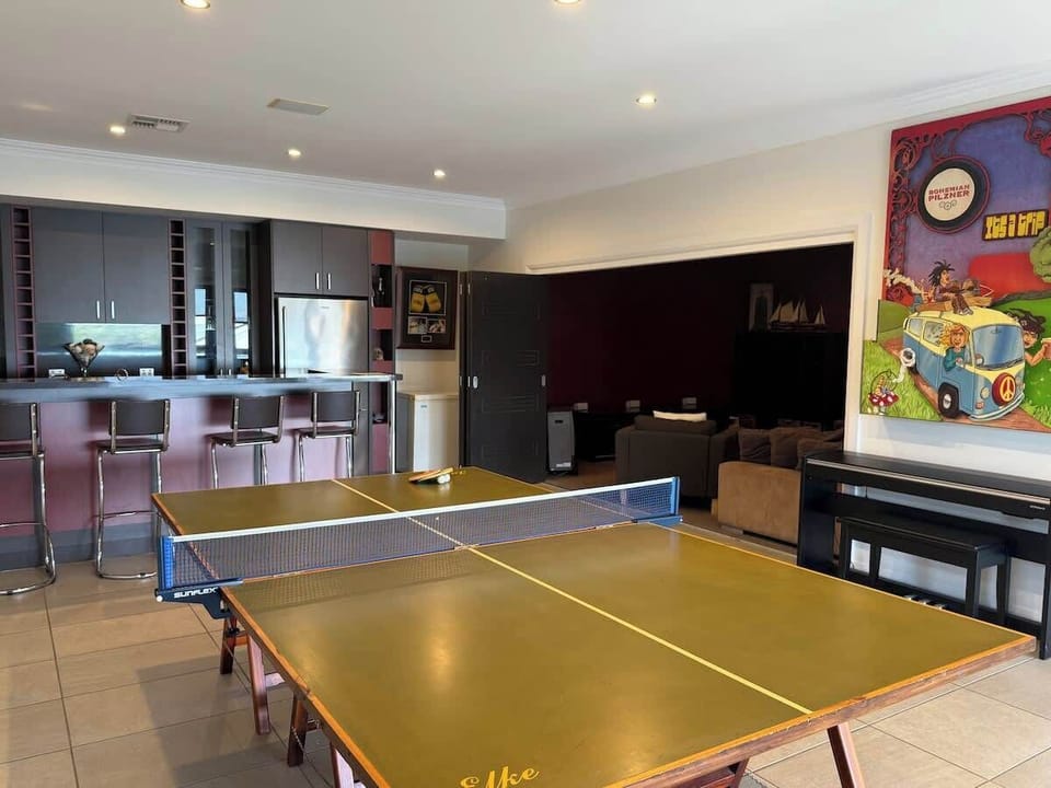 Relax and play in this stylish retreat featuring a private game lounge, bar seating, and a cozy media nook—perfect for unforgettable downtime.