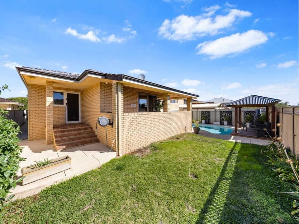 Step out into a spacious backyard that leads directly to the refreshing pool area.