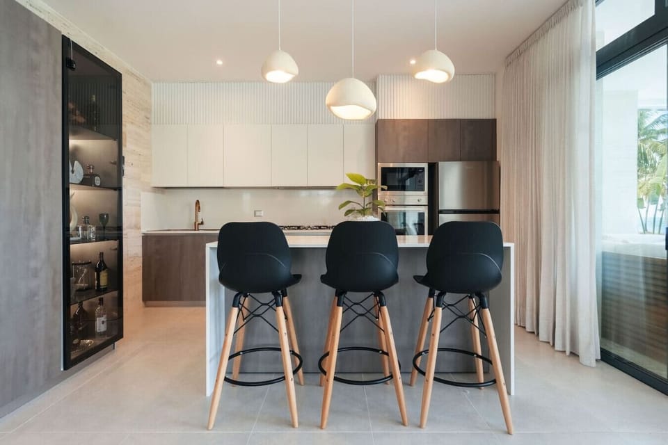 Fully equipped kitchen with island seating—perfect for quick meals or morning coffee.