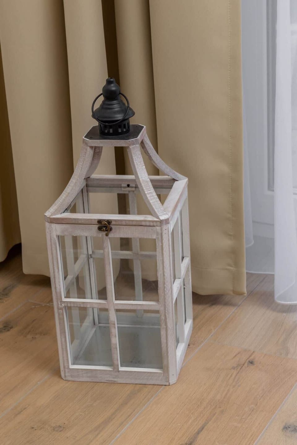 A close-up of a decorative lantern, adding a rustic yet elegant touch to the room's design.

