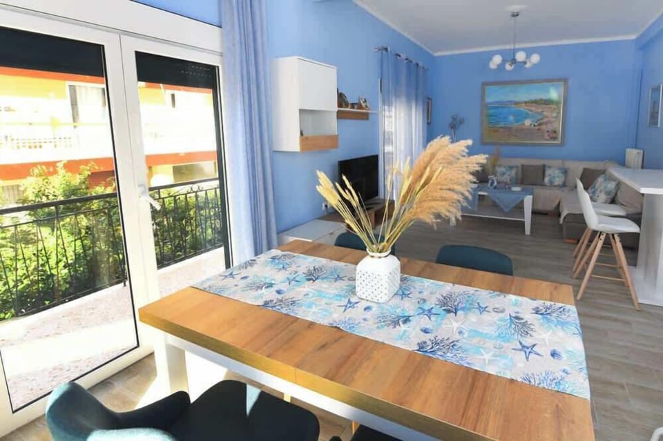 Stylish dining space, perfect for shared meals, overlooking the balcony.
