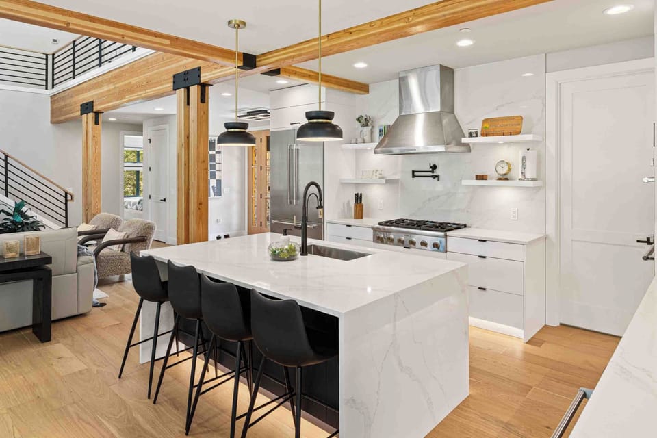 The marble island seats four and keeps the cook connected to everyone in the living room