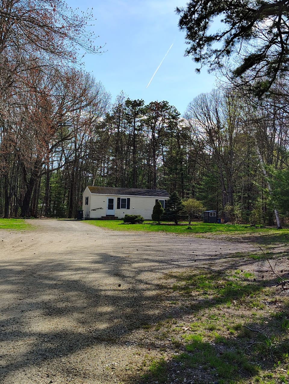 plenty of parking on gravel drive, cottage nestled in back of lot