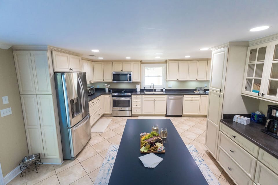 Bright kitchen with island and stainless steel appliances