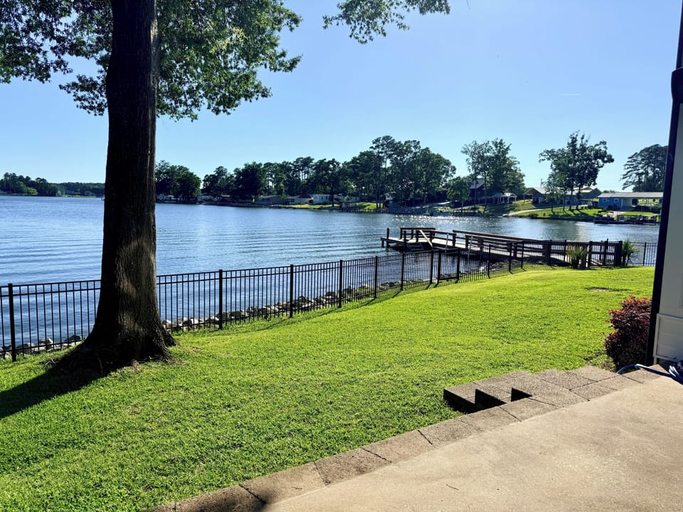 Waterfront lawn and dock with peaceful lake views