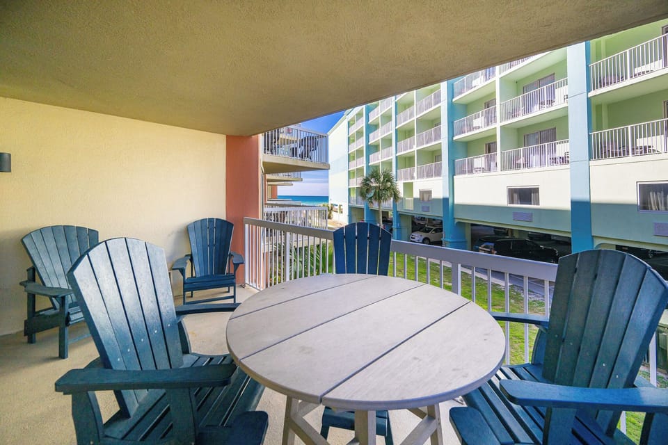 Your balcony invites quiet mornings with a distant glimpse of the sparkling gulf horizon beyond nearby buildings